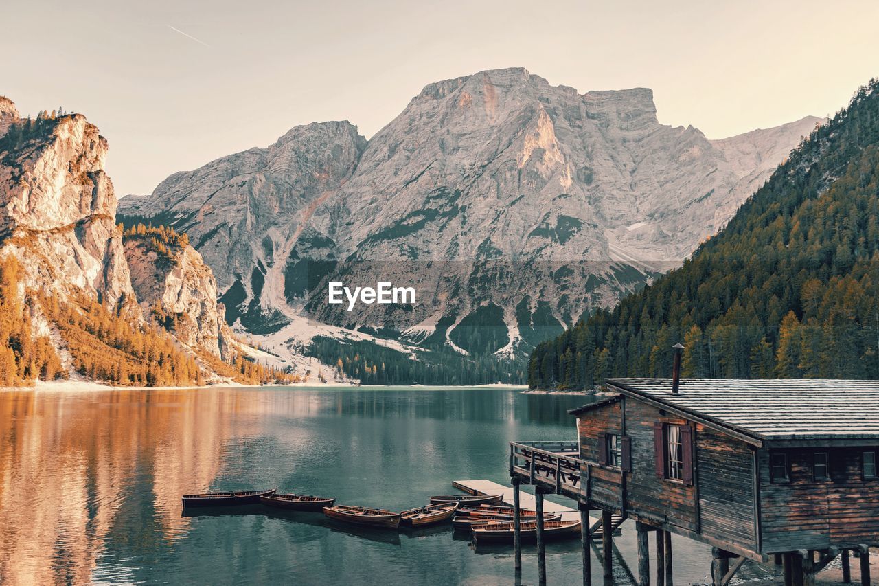 Scenic view of lake by mountains against sky. boathouse at a lake.