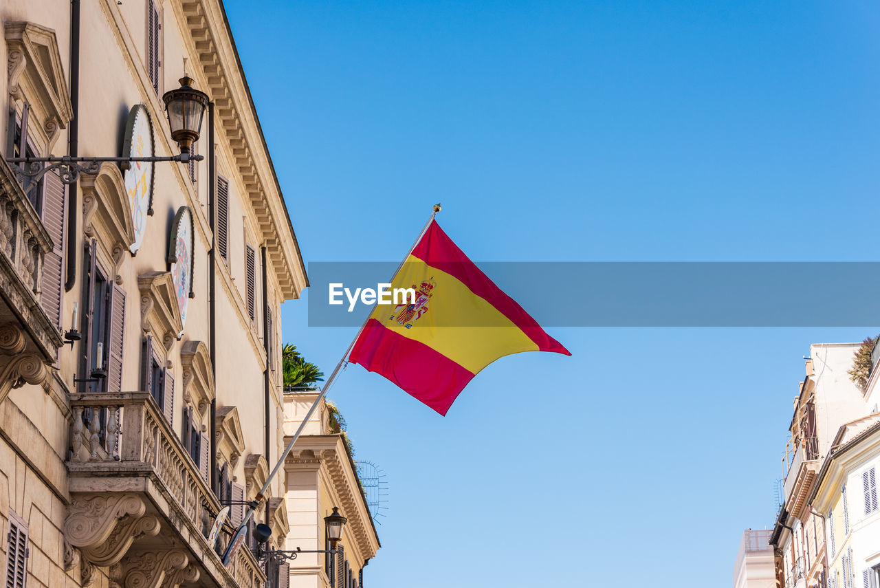 Waving spanish flag on spanish embassy in italy. palace of spain, monaldeschi palace