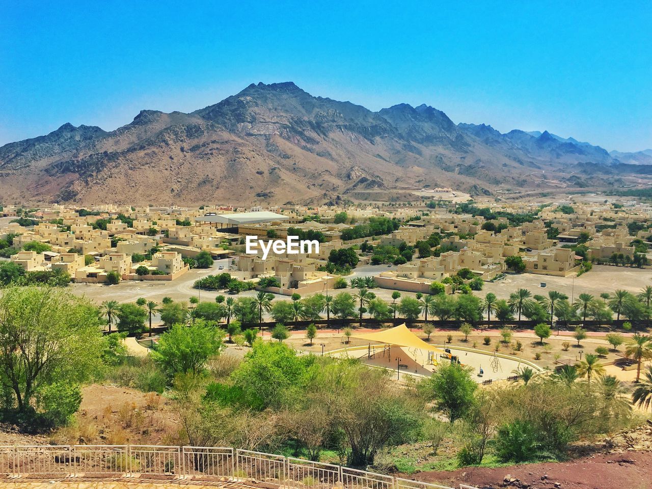 High angle view of houses by mountains against sky