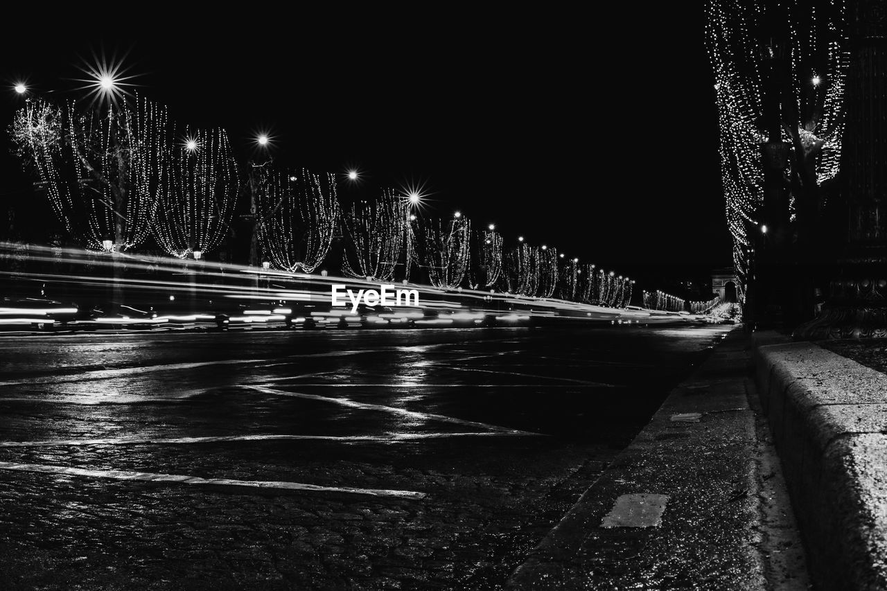 ILLUMINATED BRIDGE OVER RIVER IN CITY