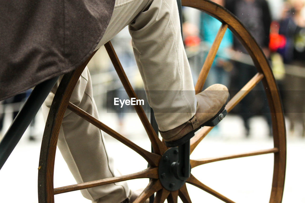 LOW SECTION OF MAN WITH BICYCLE IN THE BACKGROUND