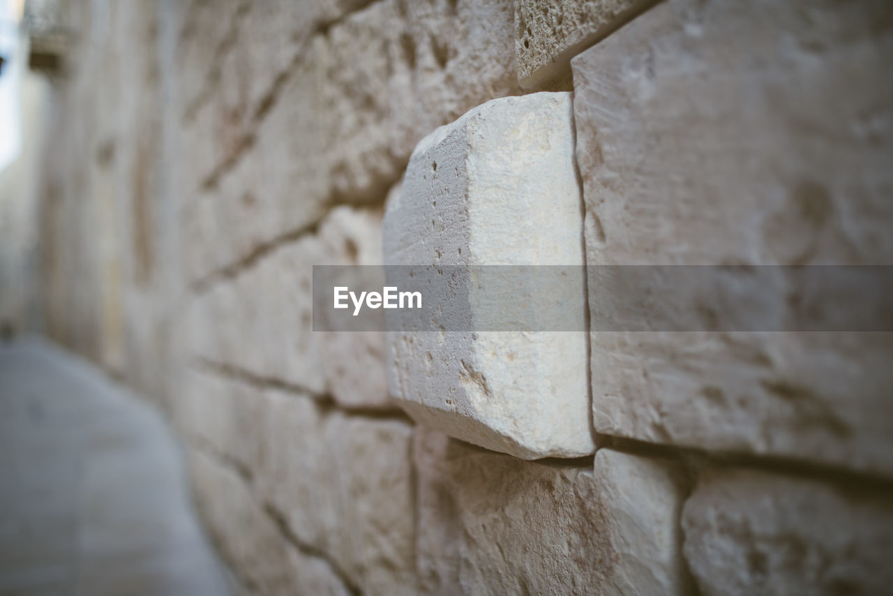 CLOSE-UP OF STONE WALL WITH CONCRETE