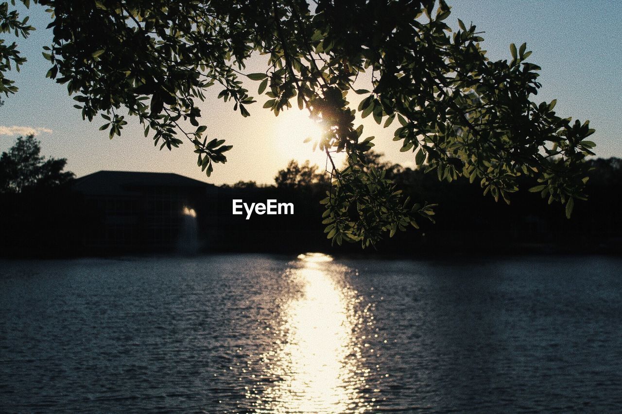 Scenic view of lake against sky at sunset