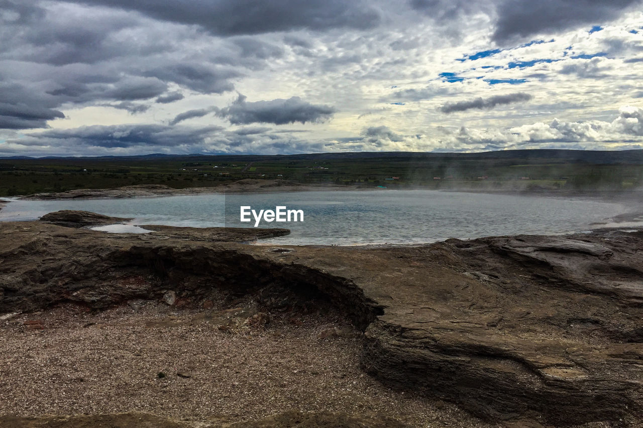 SCENIC VIEW OF SEA SHORE AGAINST SKY