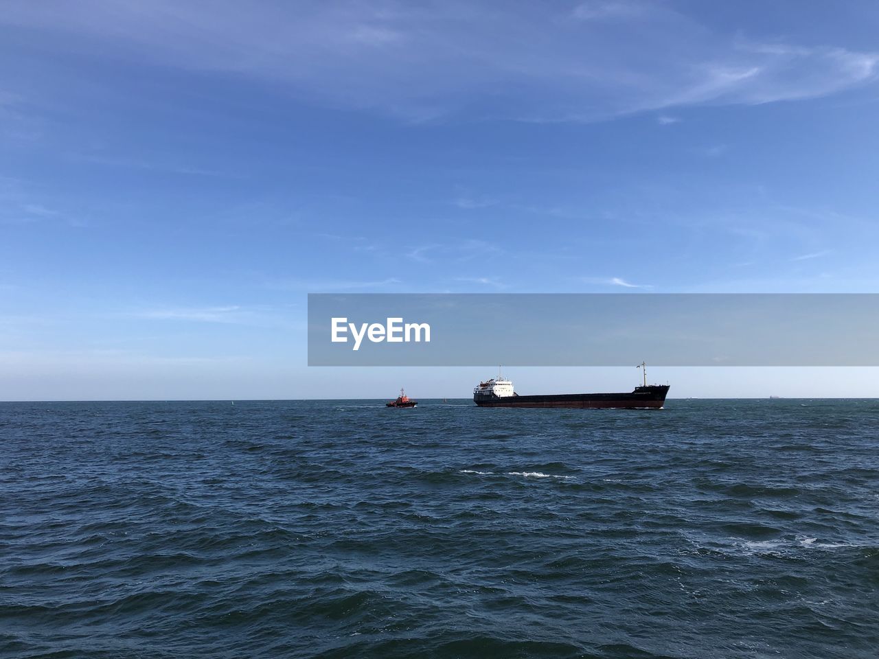 FISHING BOAT SAILING IN SEA AGAINST SKY