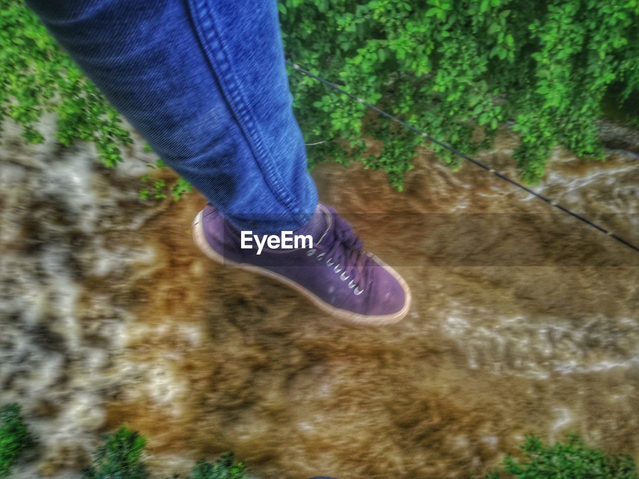 LOW SECTION OF PERSON WEARING SHOES STANDING ON LAND