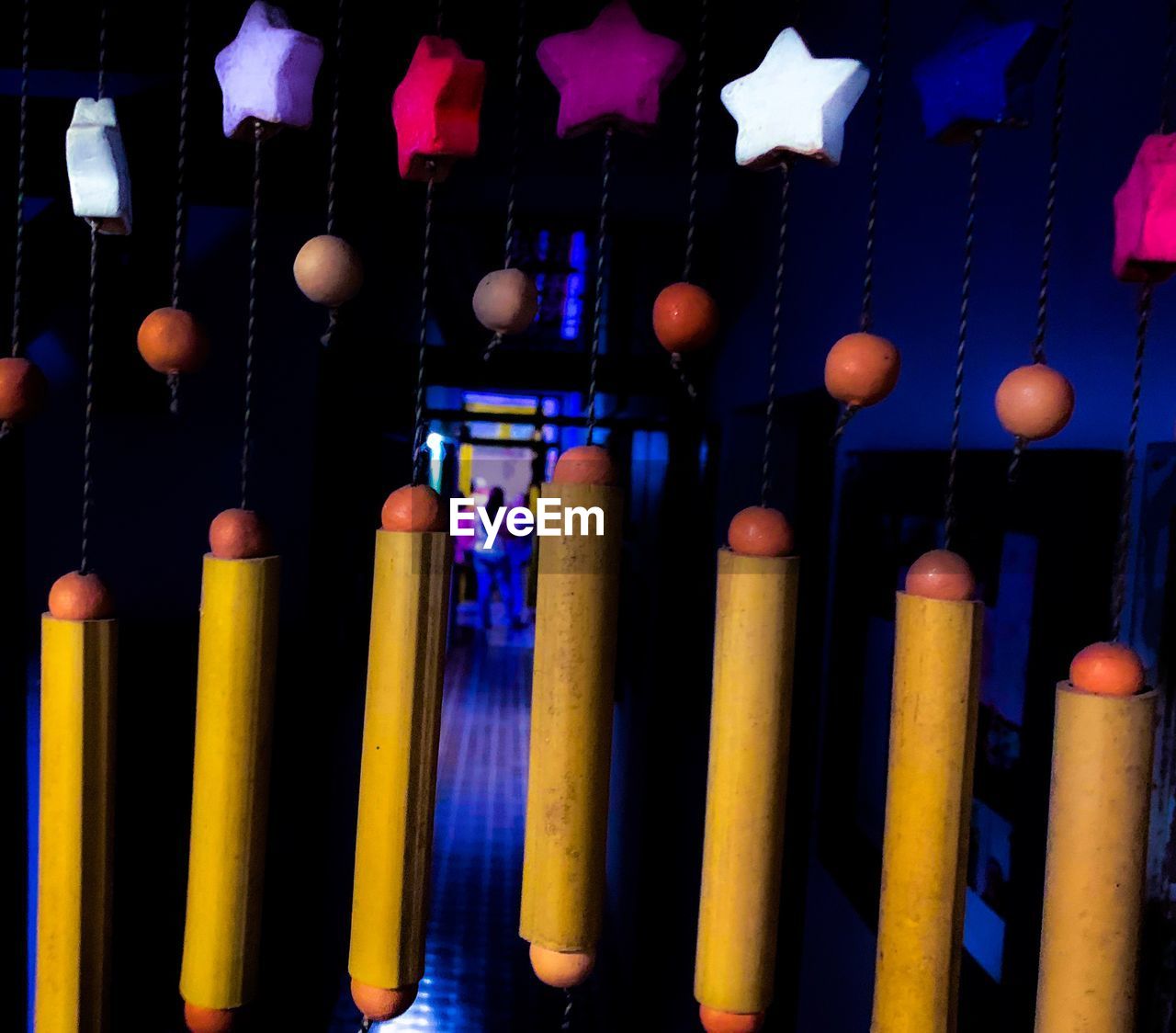 CLOSE-UP OF MULTI COLORED LIGHTS HANGING ON SHELF