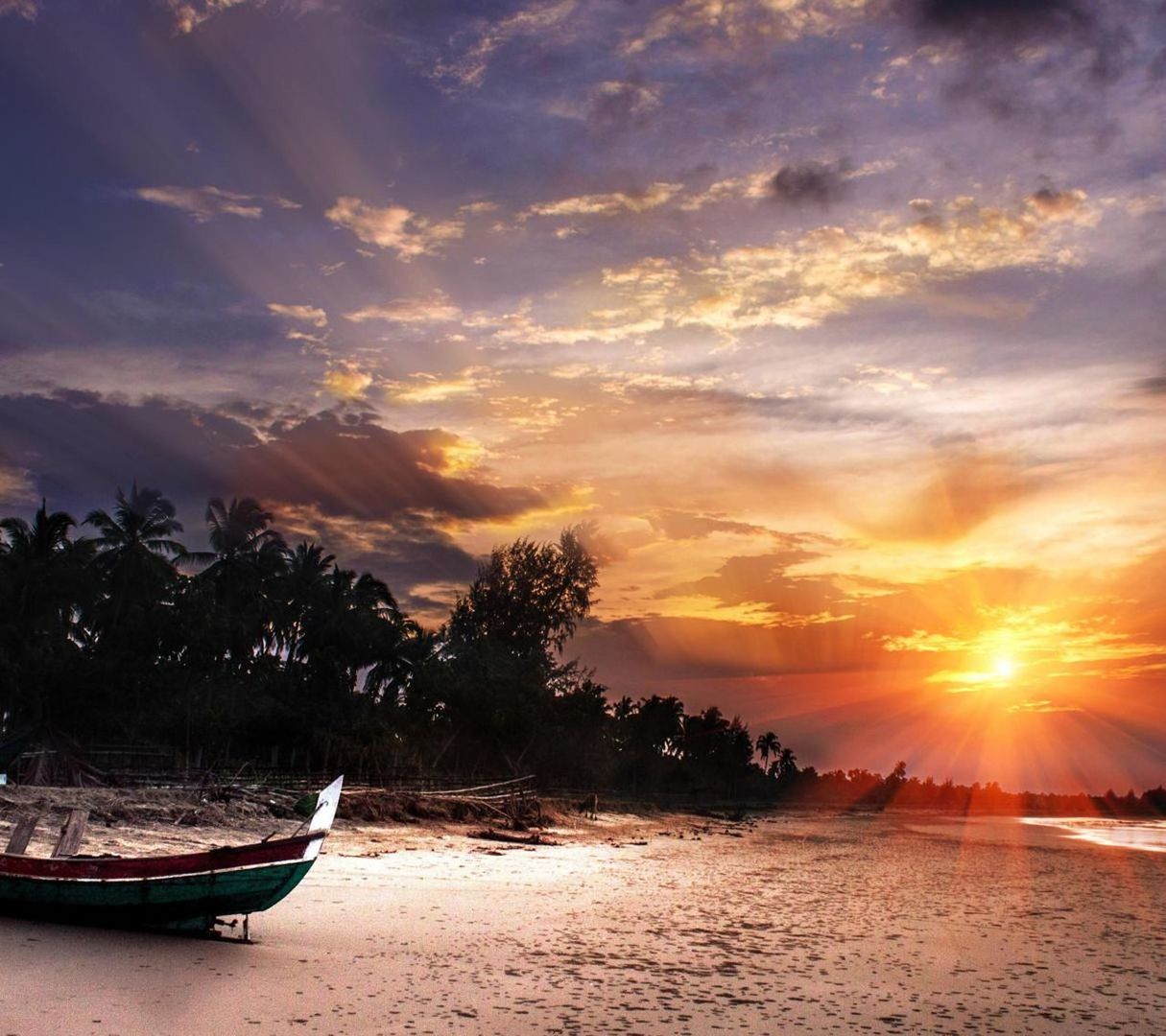 Boats moored on sea against sky during sunset