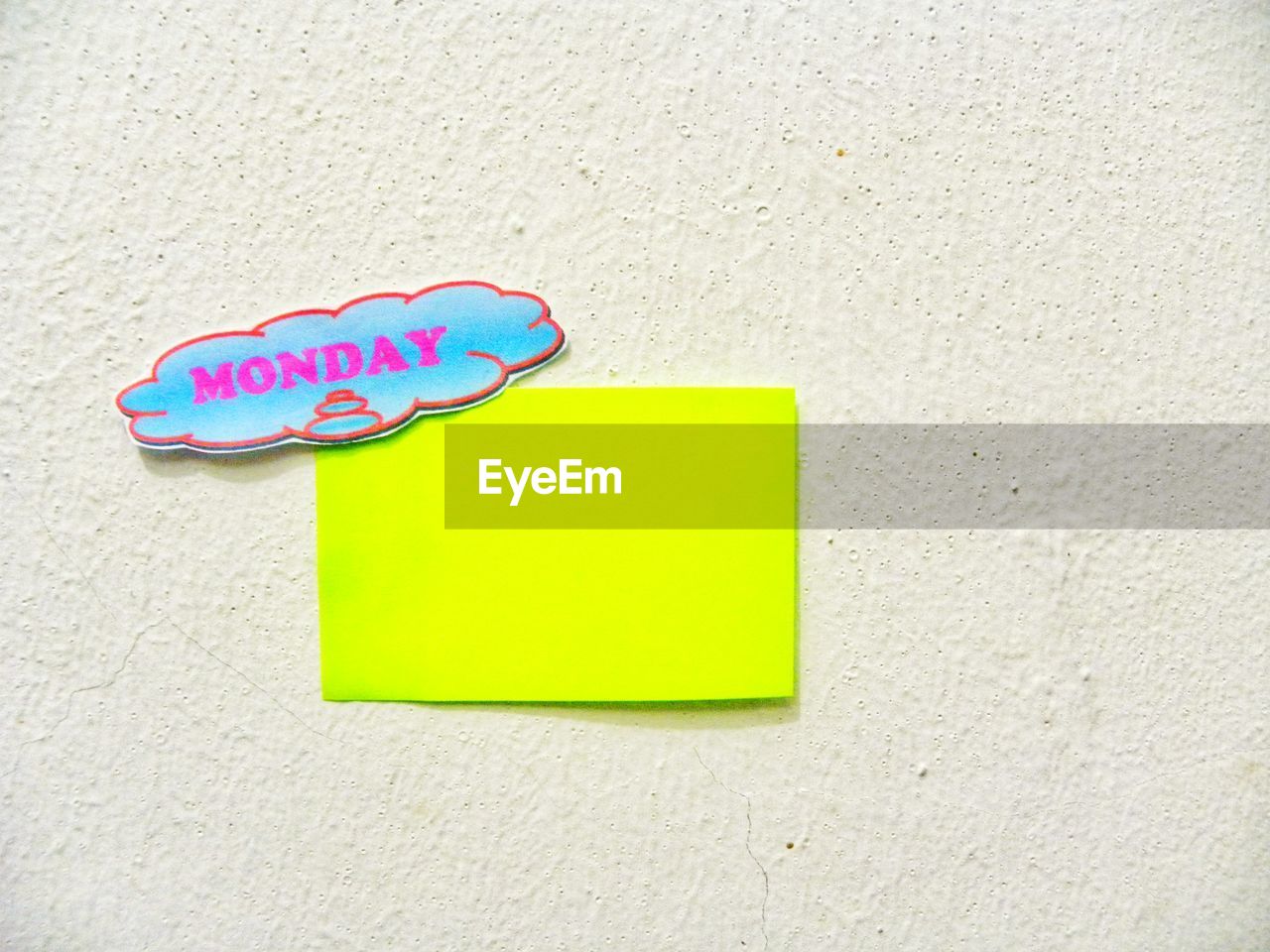 Close-up of text on speech bubble with green paper on wall