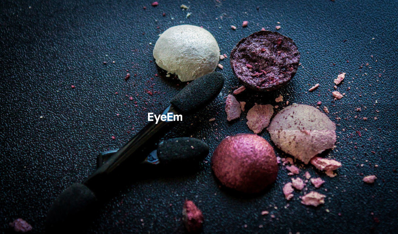 Crushed eyeshadows and brushes on table