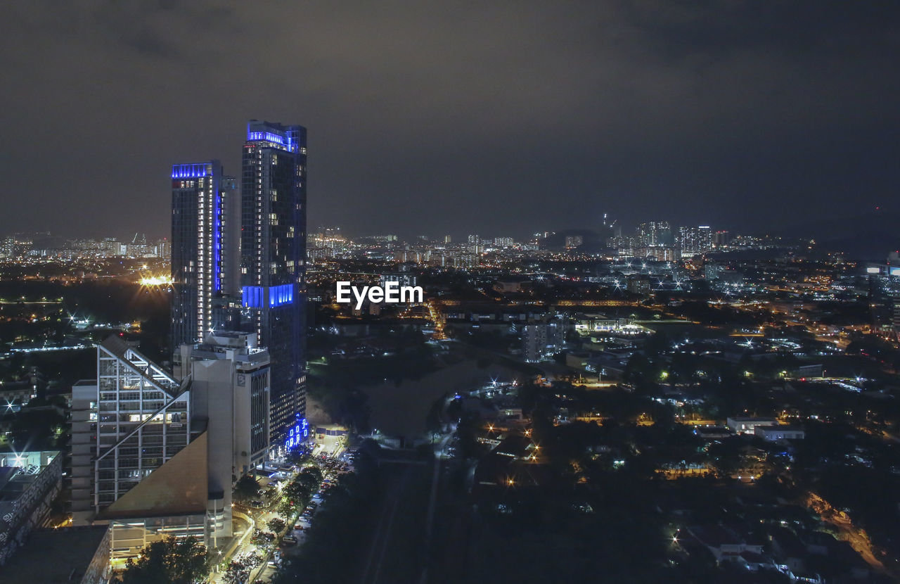 High angle view of illuminated buildings in city at night