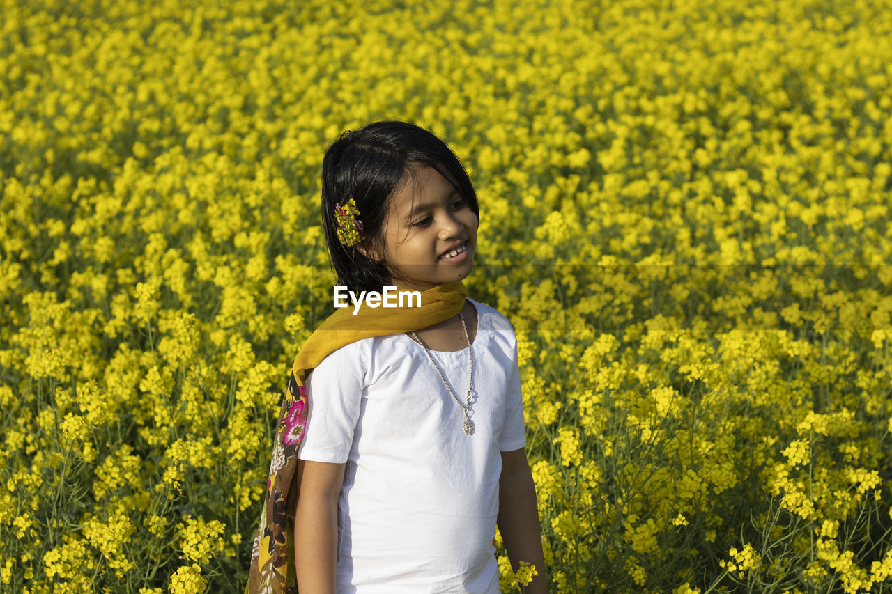 BOY STANDING ON FIELD