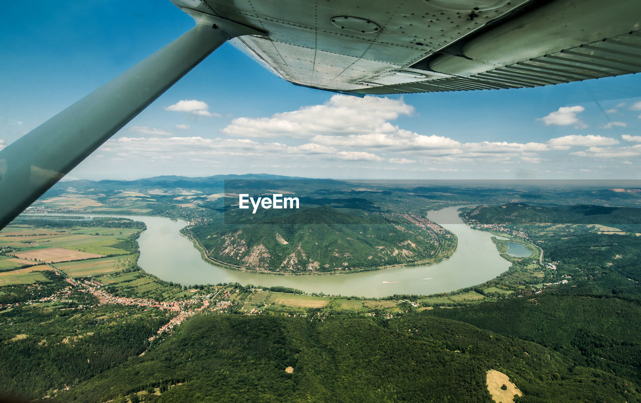 AERIAL VIEW OF AIRPLANE WING OVER LANDSCAPE