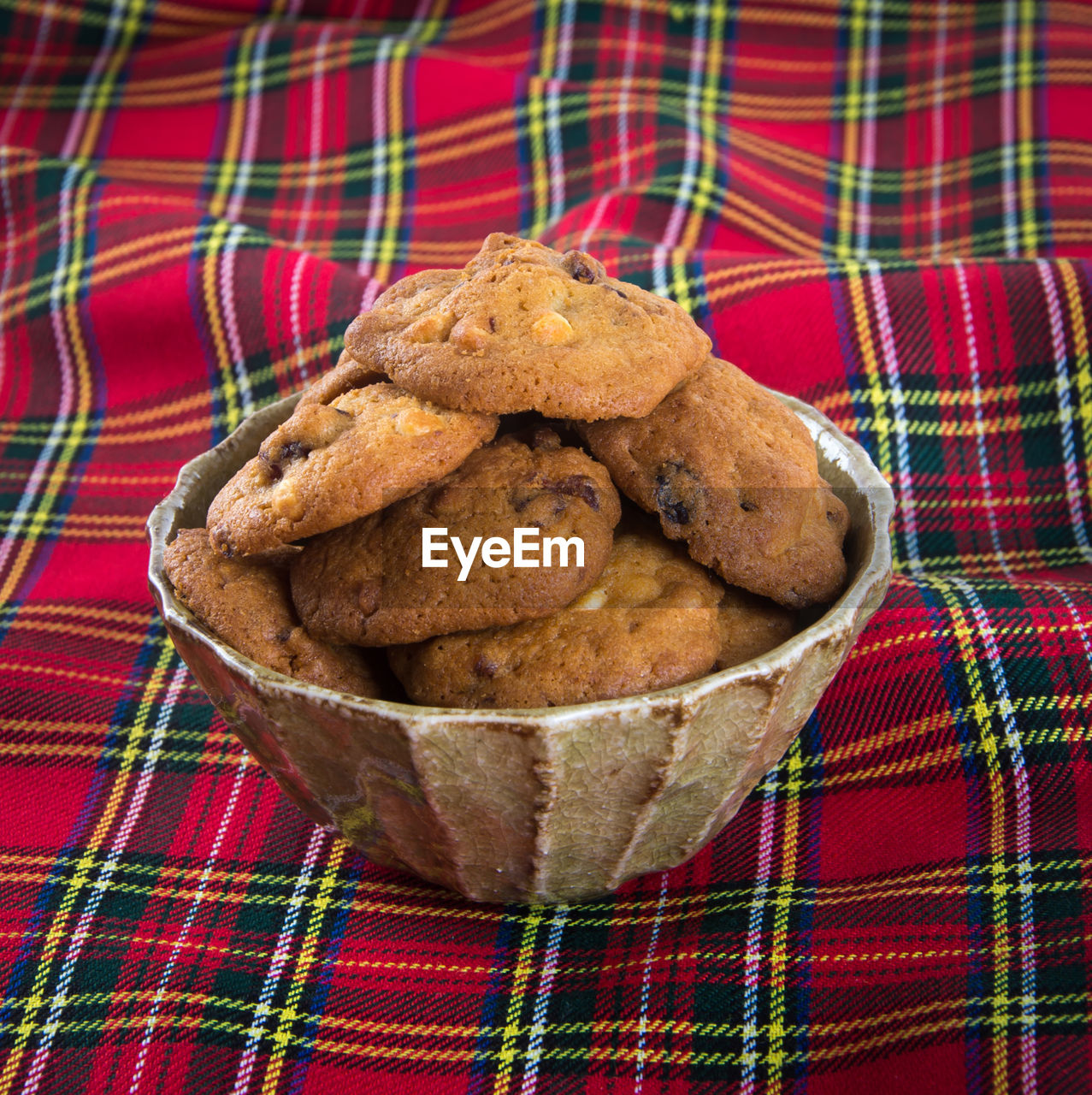 Close-up of cookies in bowl on tablecloth