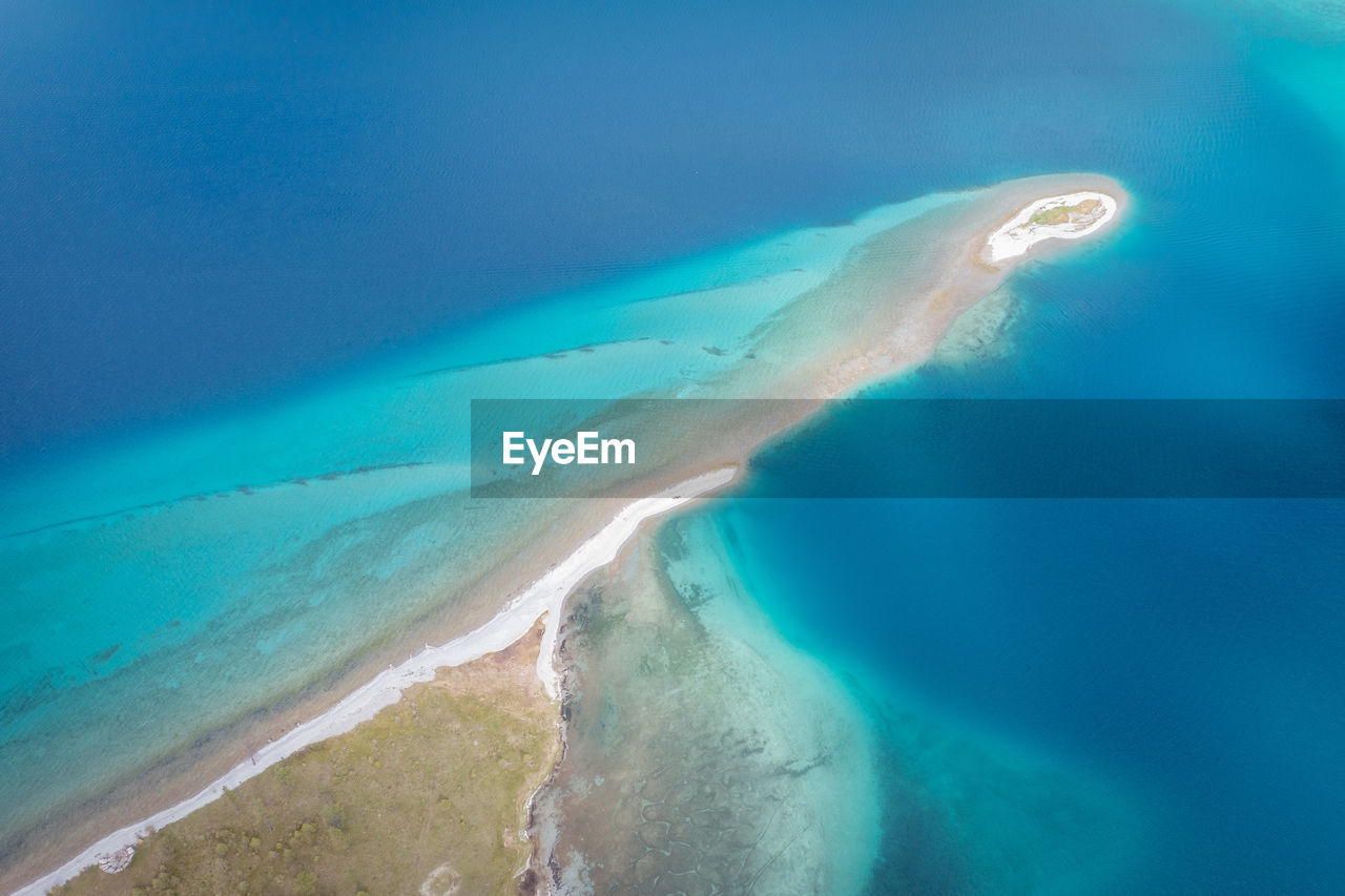 water, sea, ocean, land, nature, wave, blue, wind wave, beauty in nature, beach, scenics - nature, environment, no people, atoll, travel destinations, travel, outdoors, aerial view, landscape, turquoise colored, tranquility, sand, underwater, day, island, azure, lagoon, tranquil scene, sky, motion