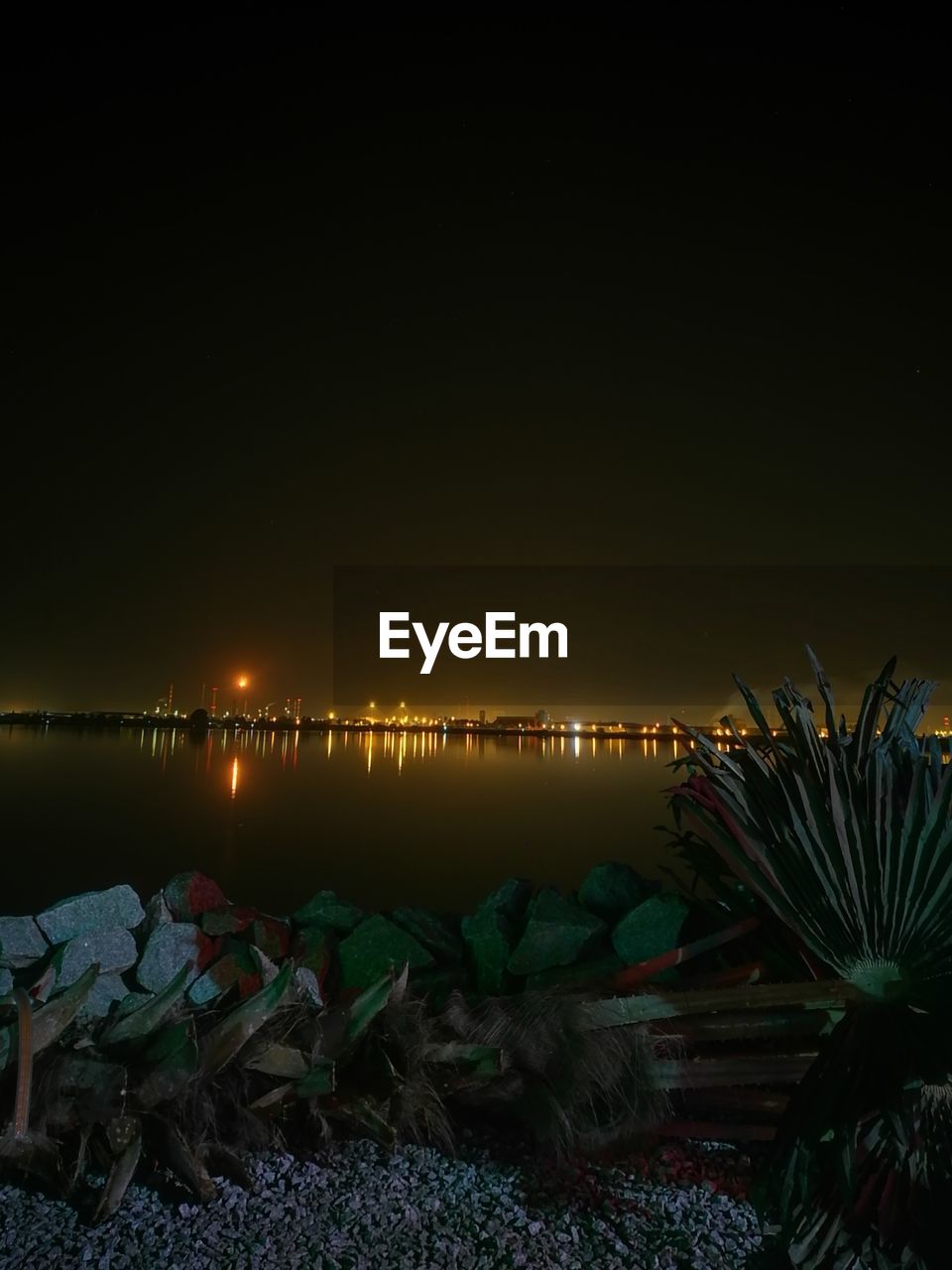 ILLUMINATED BEACH AGAINST CLEAR SKY AT NIGHT