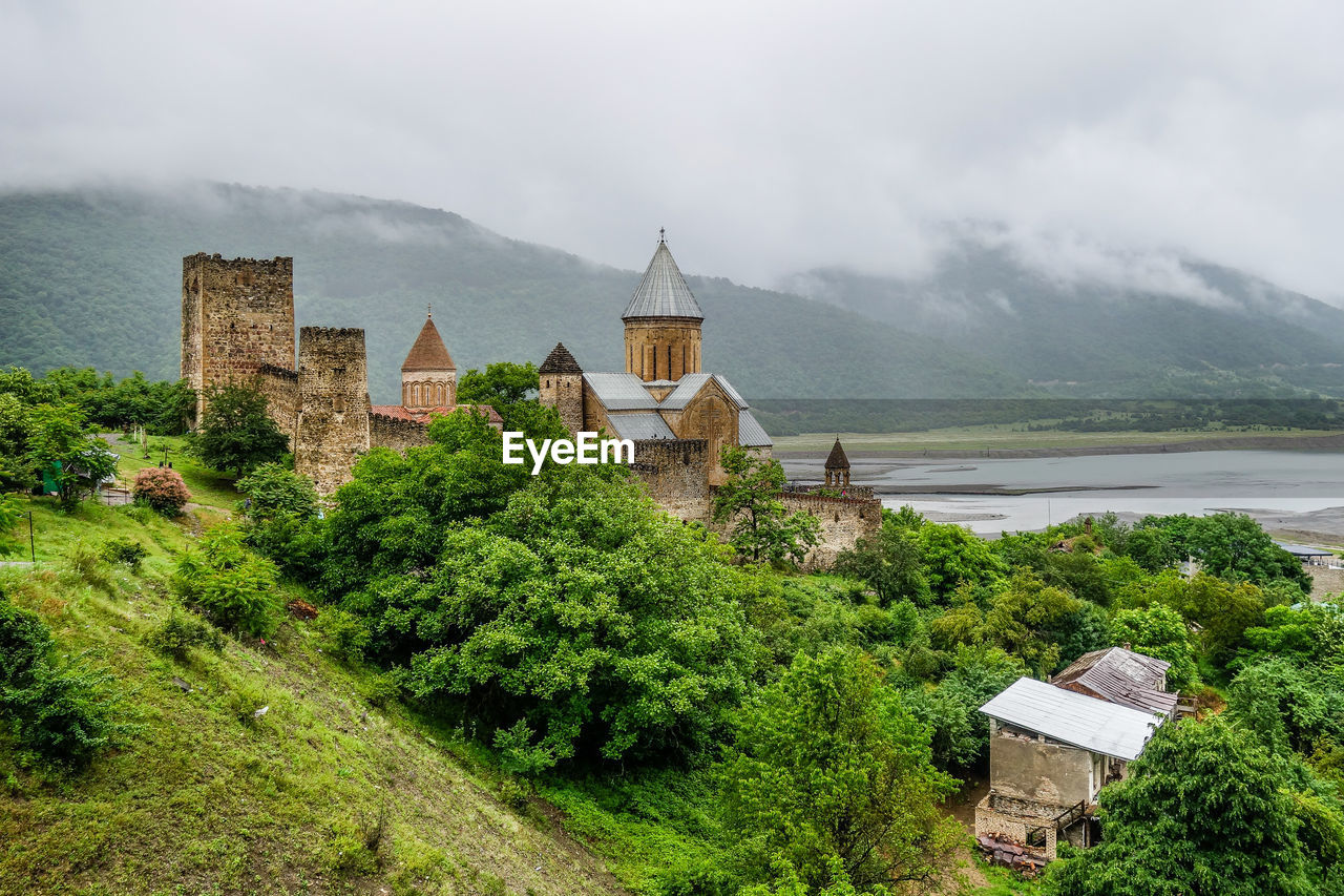 Scenic view of monastery  and lake against sky