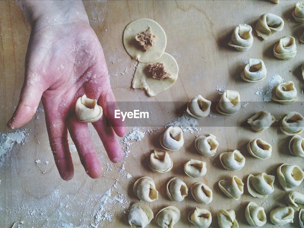 Hand holding raw tortellini