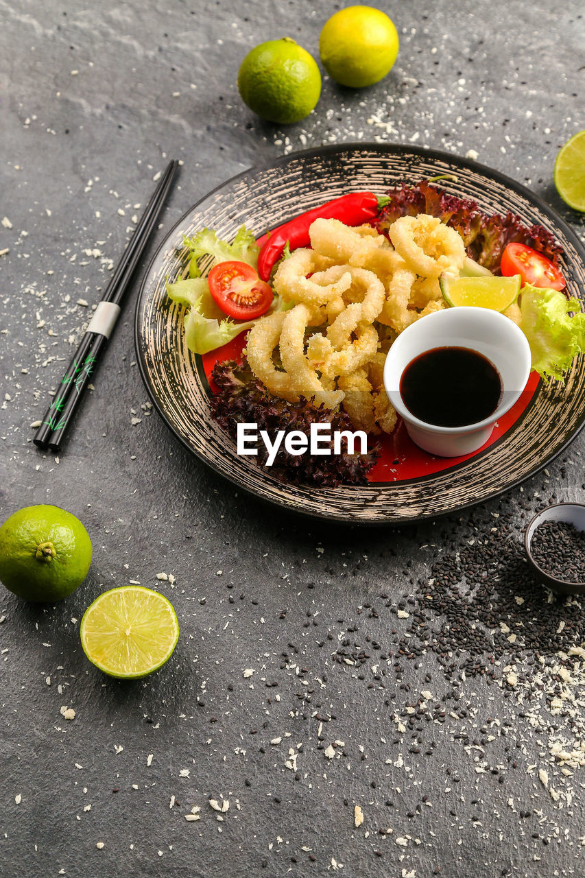 High angle view of food in plate on stone tray