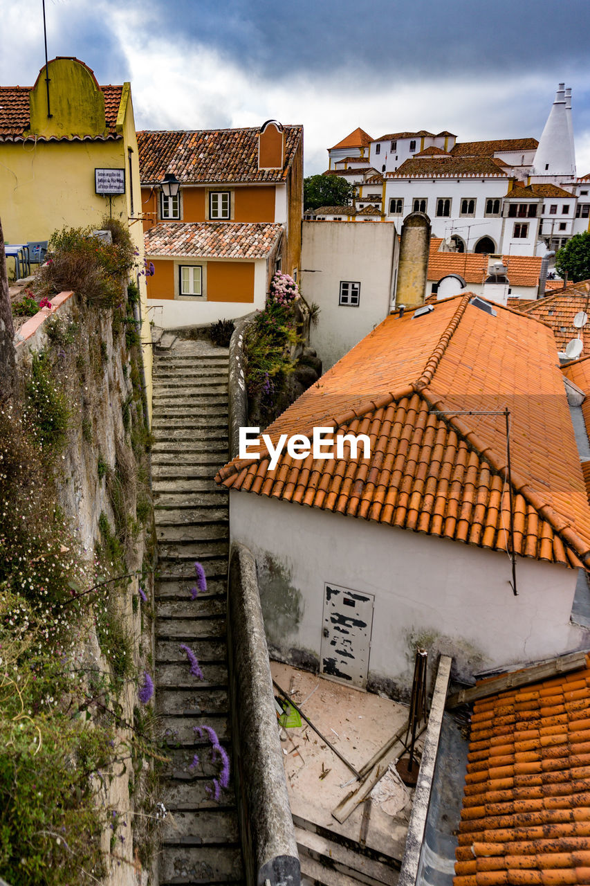 High angle view of houses in town against sky