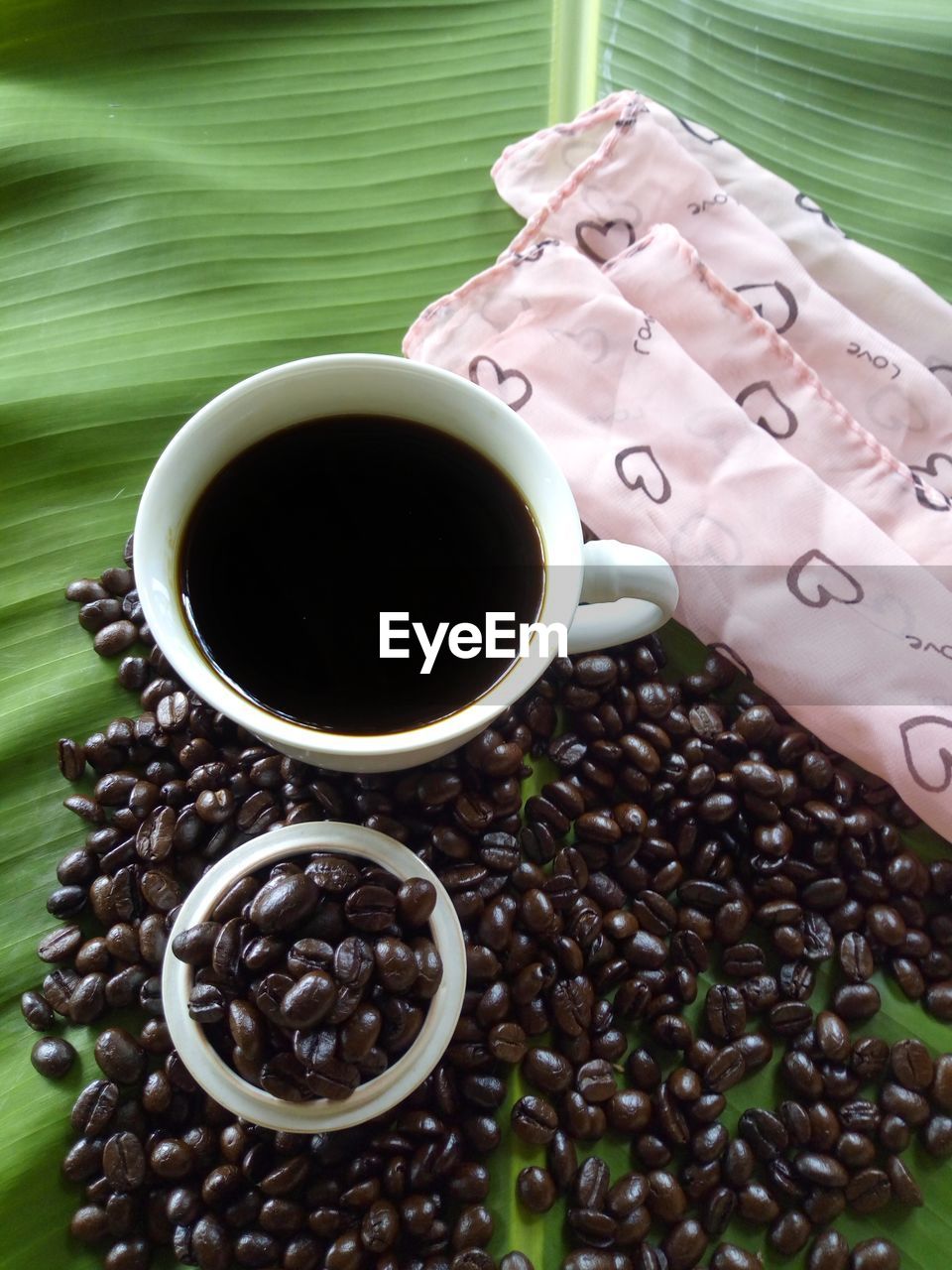 HIGH ANGLE VIEW OF COFFEE CUP ON TABLE WITH BLACK BACKGROUND