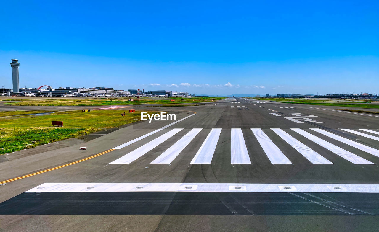 ROAD BY AIRPLANE AGAINST BLUE SKY