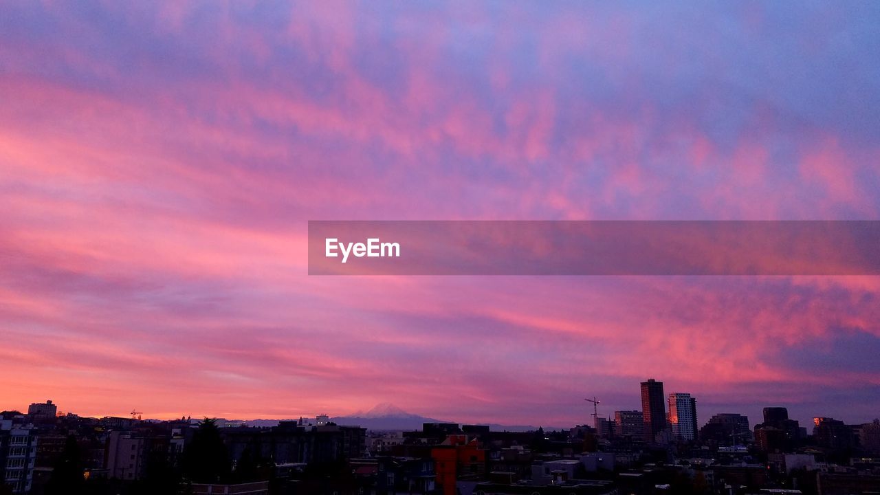 CITYSCAPE AGAINST SKY AT SUNSET