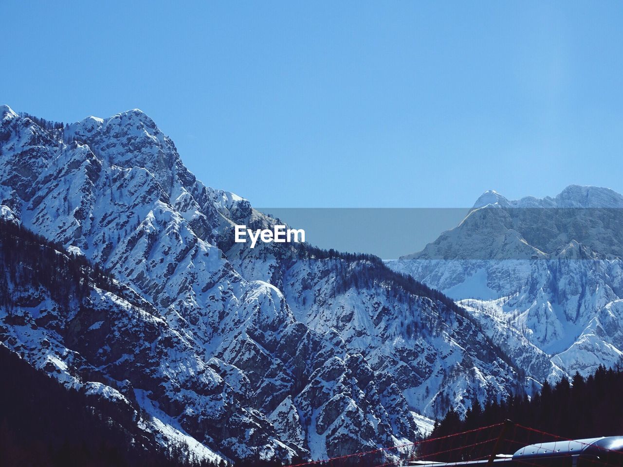 Snowcapped mountains against cloudy sky