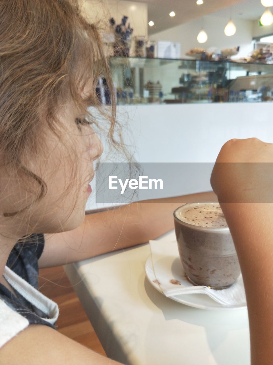 MIDSECTION OF WOMAN DRINKING COFFEE CUP