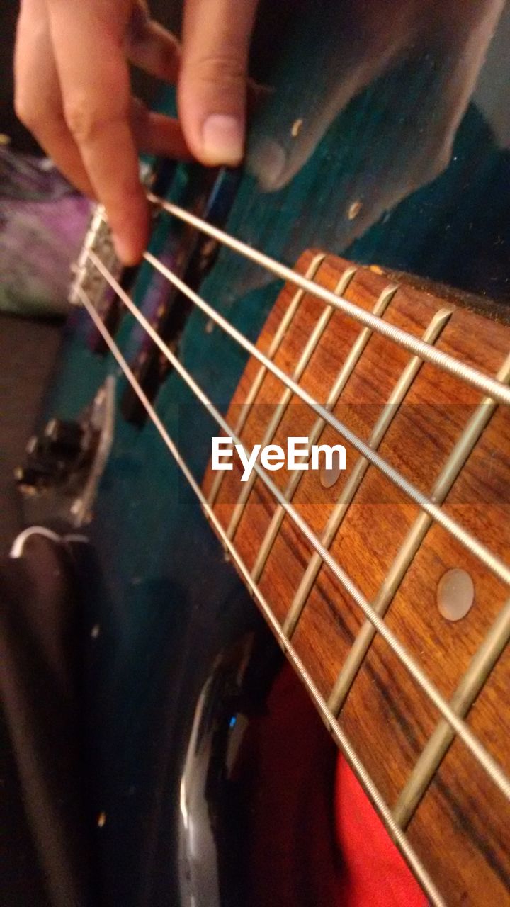 CLOSE-UP OF HANDS PLAYING GUITAR