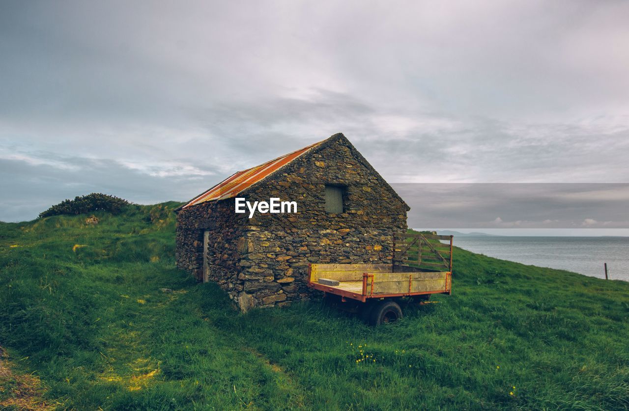 House on shore against sky