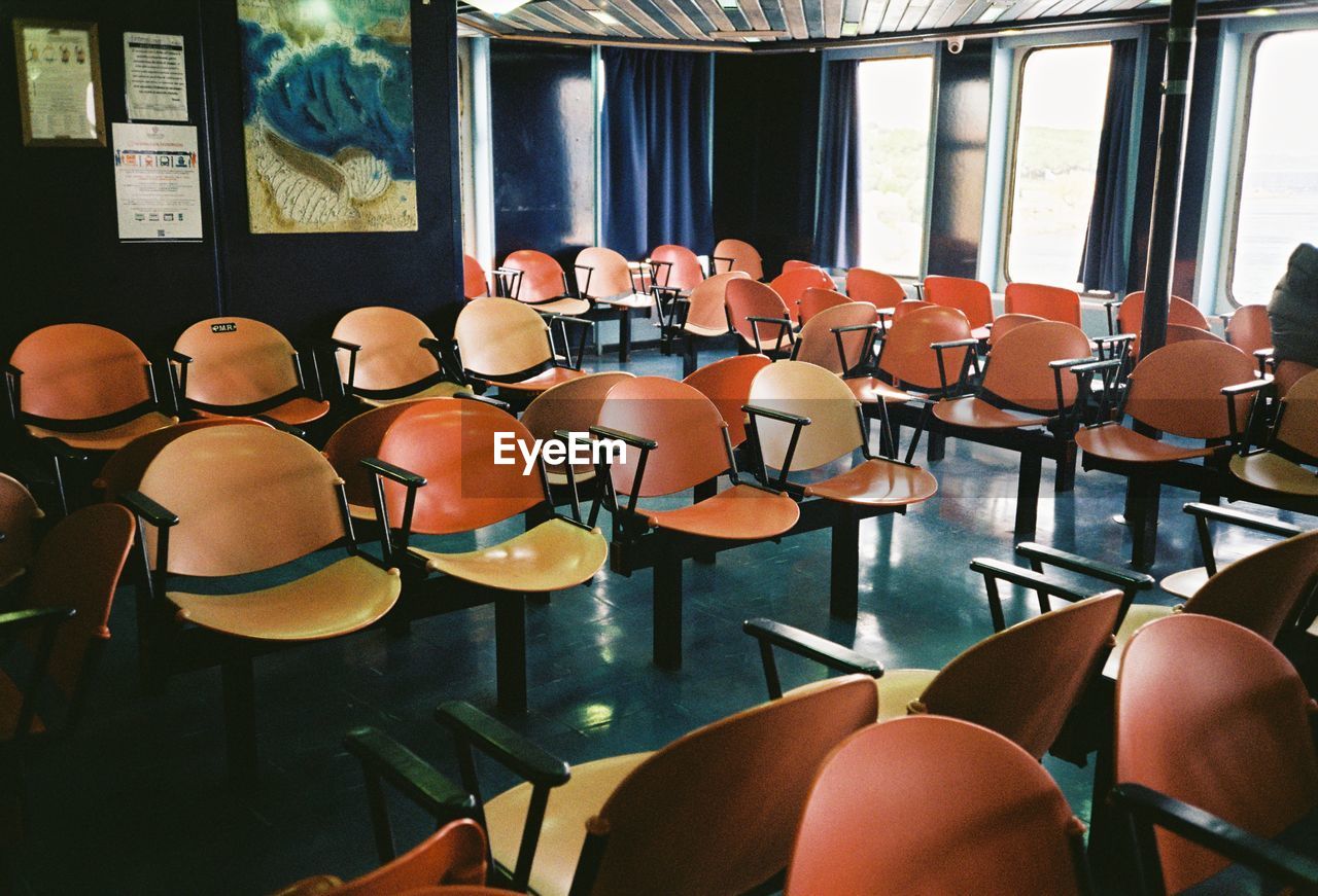 EMPTY CHAIRS AND TABLES IN RESTAURANT