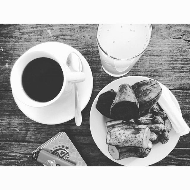 COFFEE CUP WITH COFFEE CUP ON TABLE