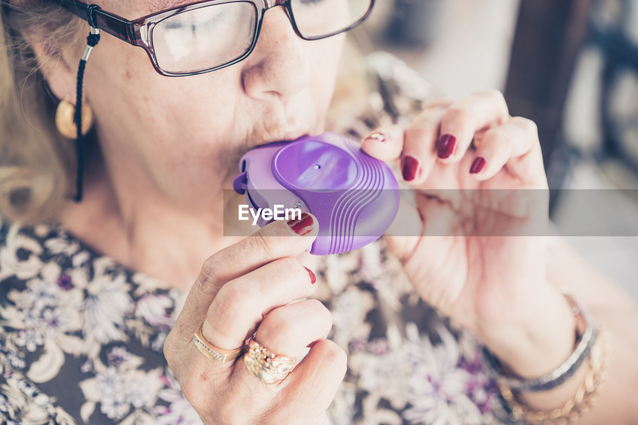 Portrait of woman holding eyeglasses