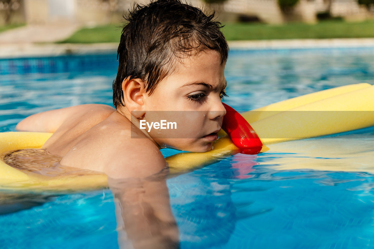 Boy swimming in pool