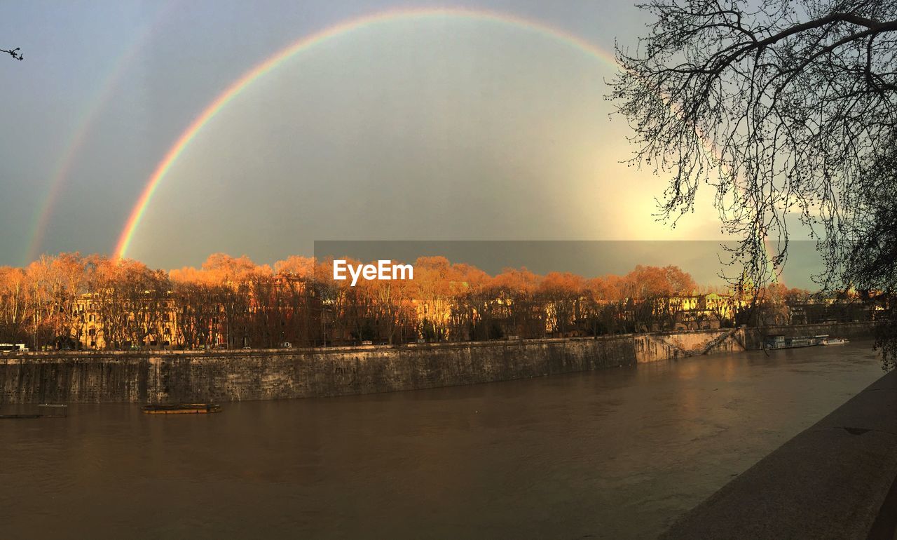 Rainbow over countryside landscape with waterfront