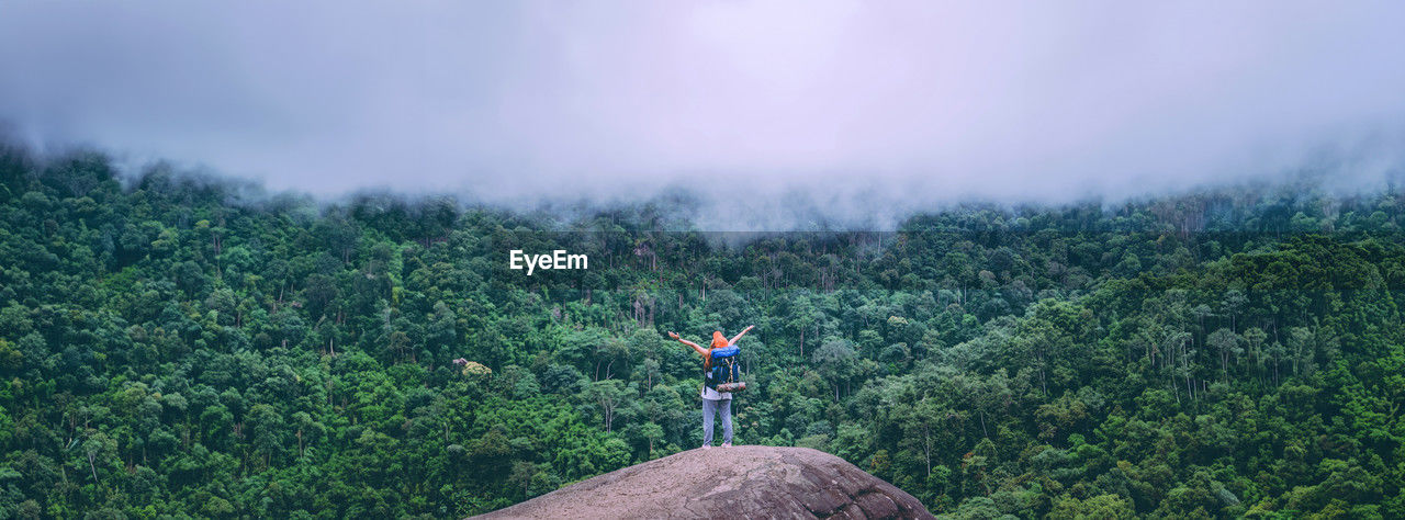 rear view of man standing on mountain