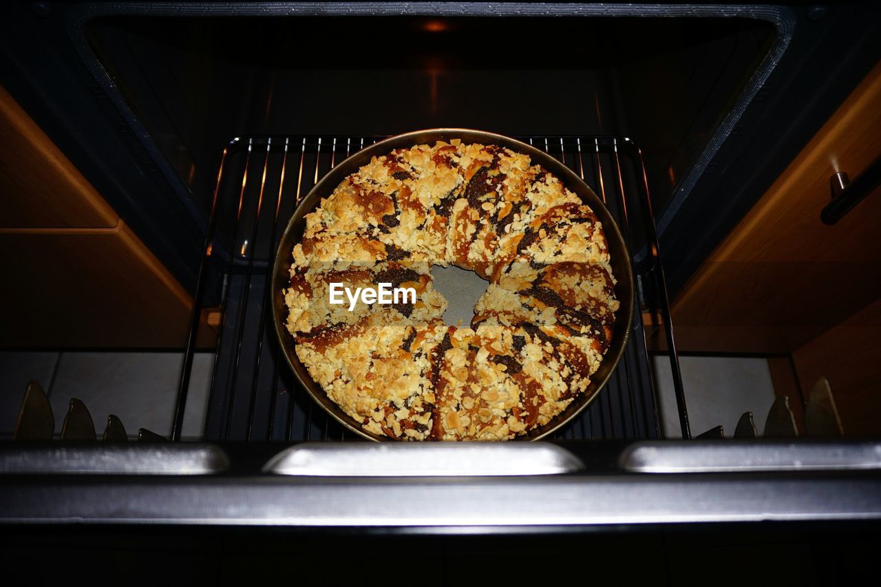 Directly above shot of baked poppy seed cake slices in container on oven