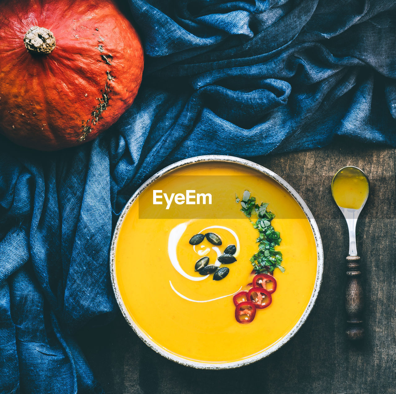 Pumpkin soup in bowl on table