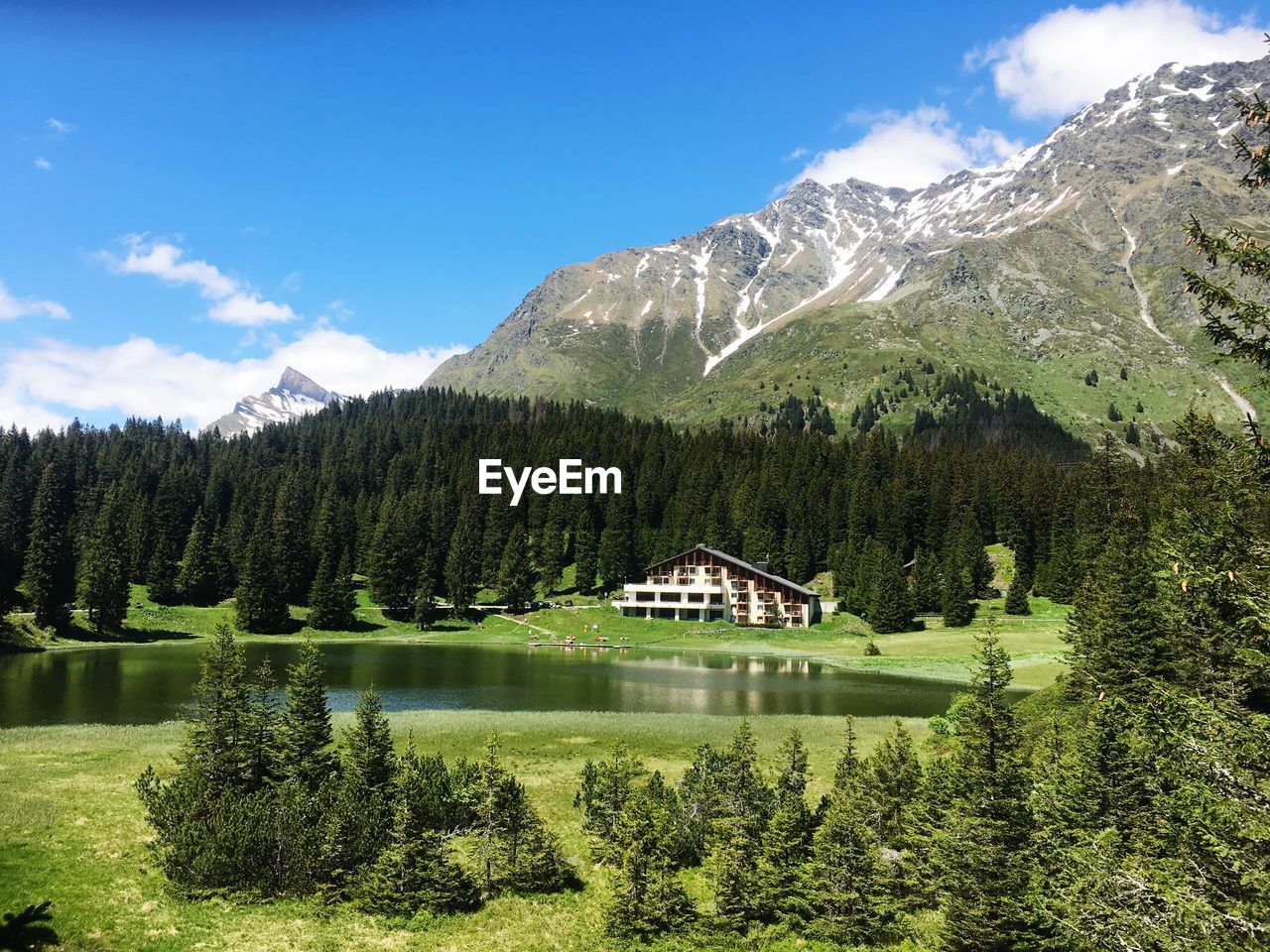 Scenic view of lake by trees against sky