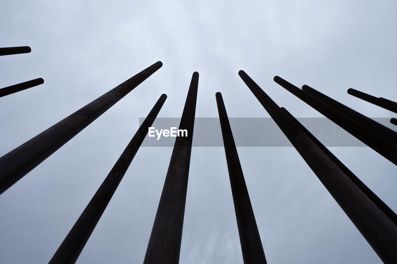 Low angle view of poles against sky at holocaust memorial