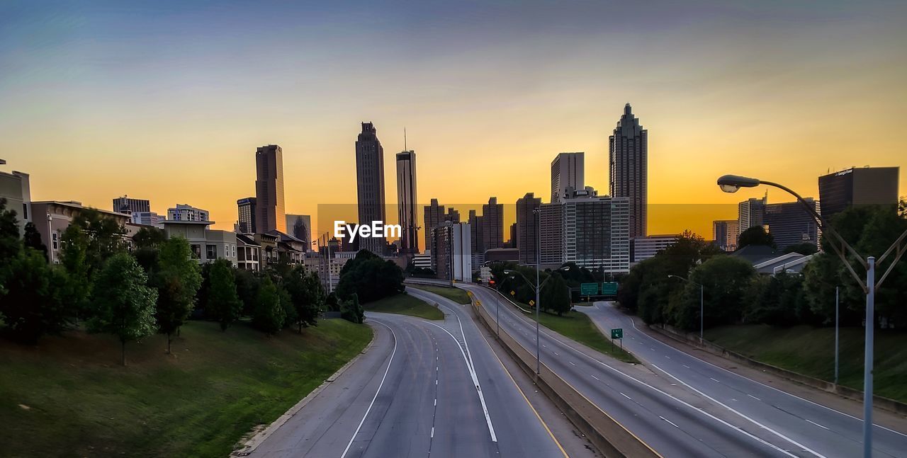 Panoramic view of city buildings against sky during sunset