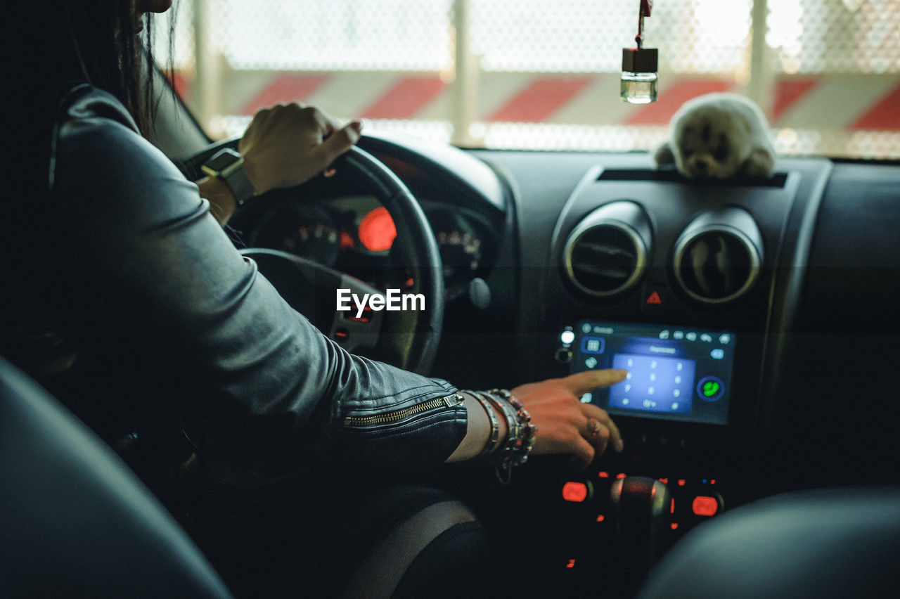 Side view of woman driving car