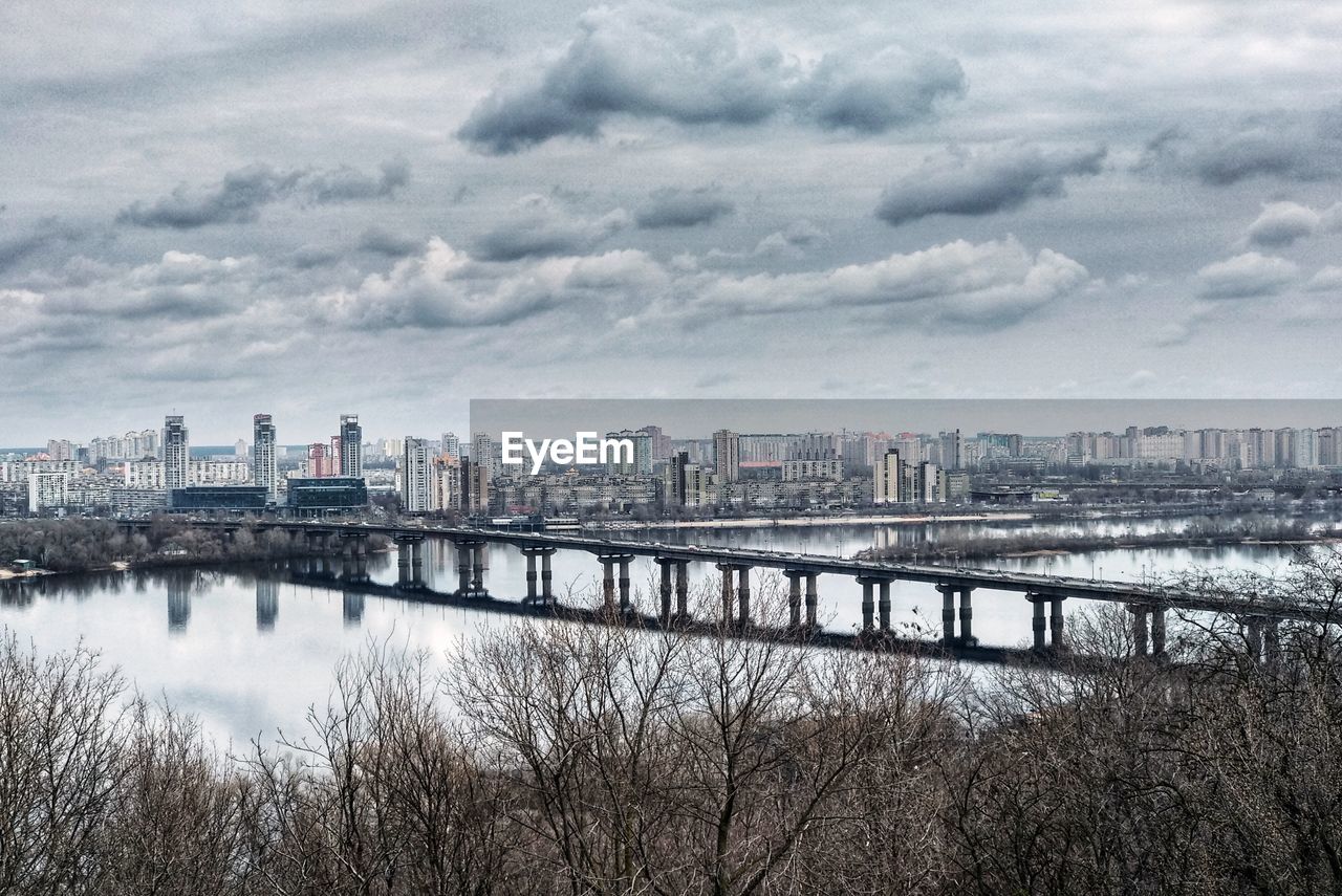 River by buildings against sky in city