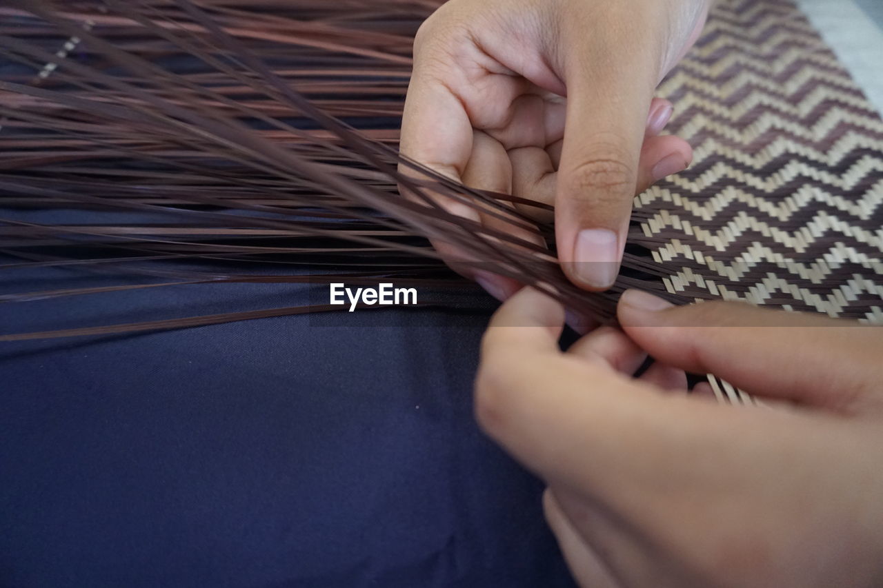 High angle view of person weaving on table