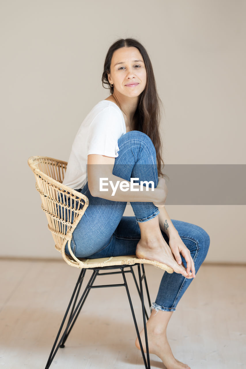 portrait of young woman sitting on chair