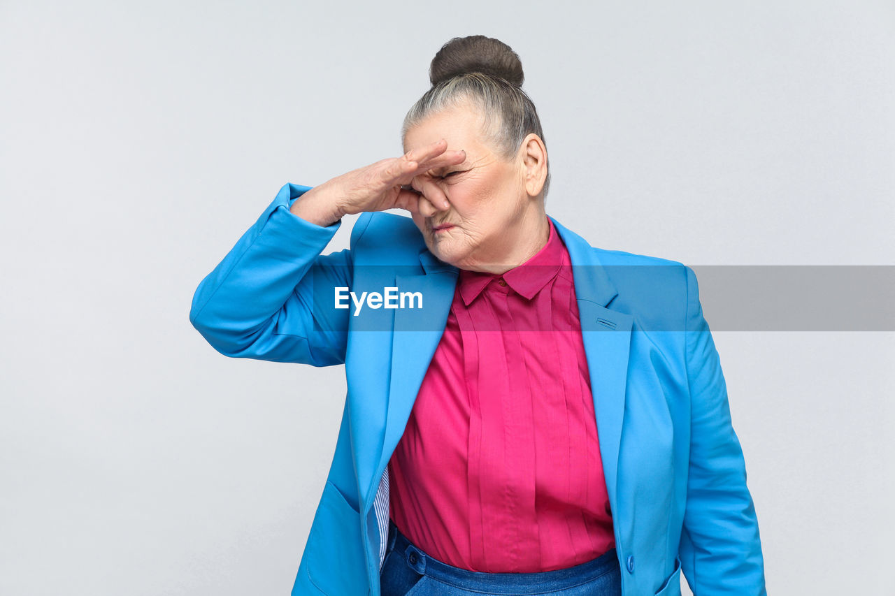 MID ADULT MAN AGAINST BLUE BACKGROUND