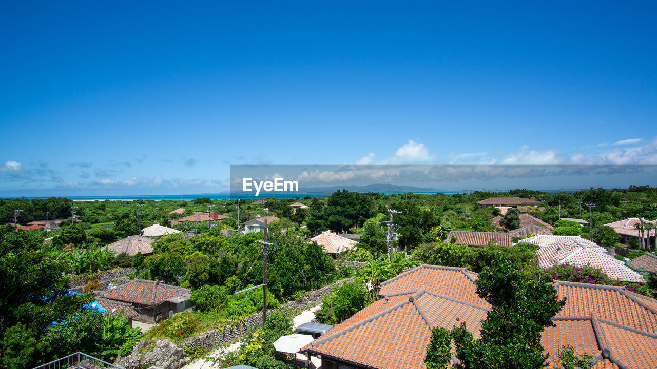 High angle view of townscape against blue sky