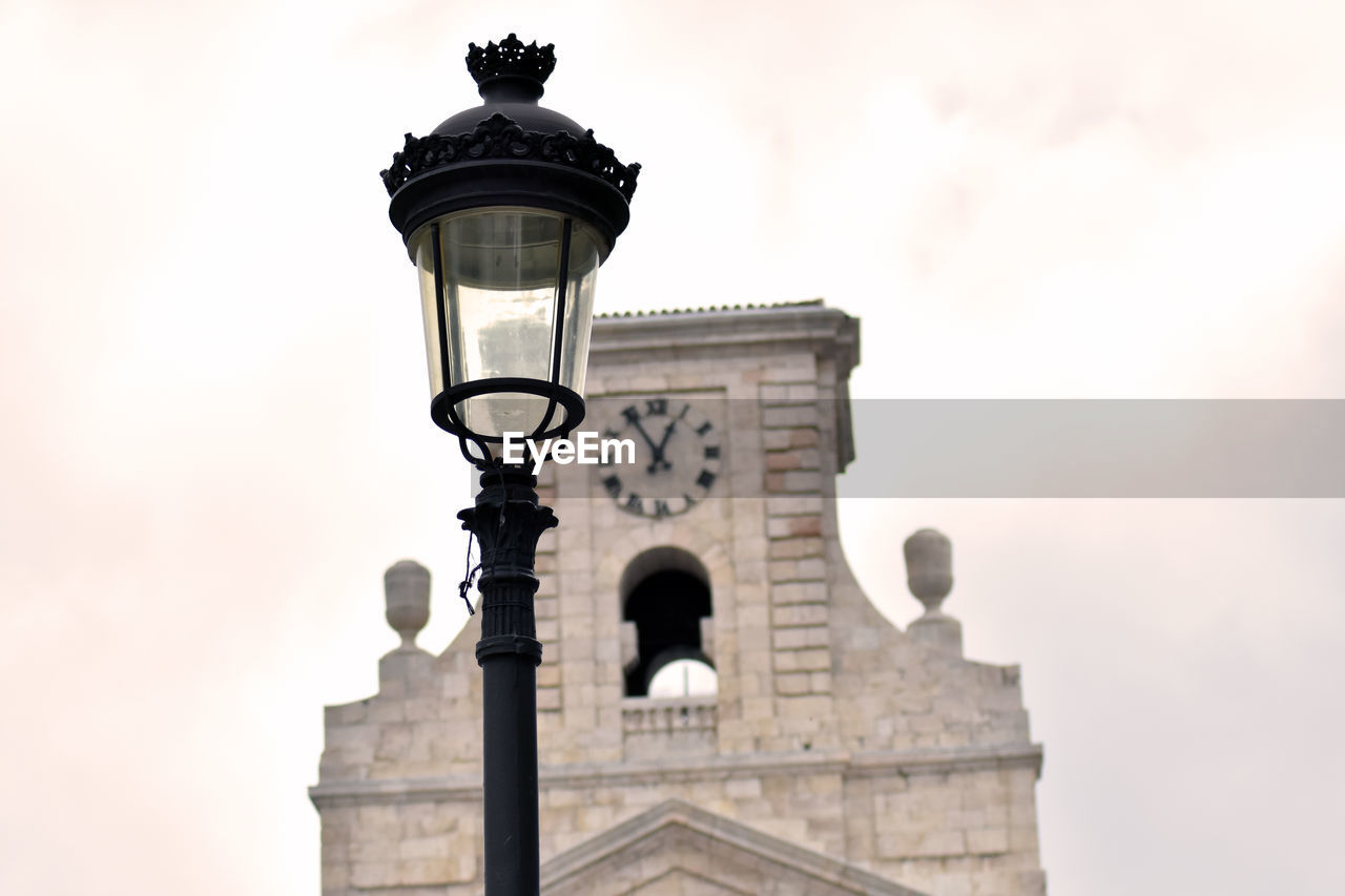 Low angle view of street light against building