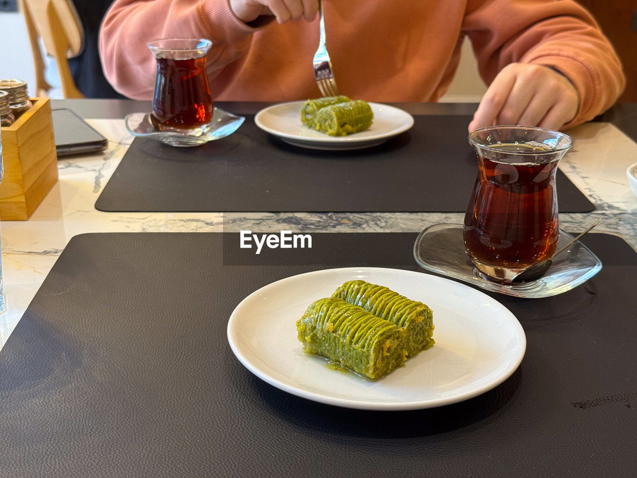 food and drink, food, table, plate, drink, healthy eating, meal, freshness, refreshment, wellbeing, restaurant, adult, one person, business, dinner, dish, alcohol, lunch, glass, indoors, supper, vegetable, midsection, eating, drinking glass, household equipment, lifestyles, hand, sitting, men, cuisine, crockery, high angle view, eating utensil